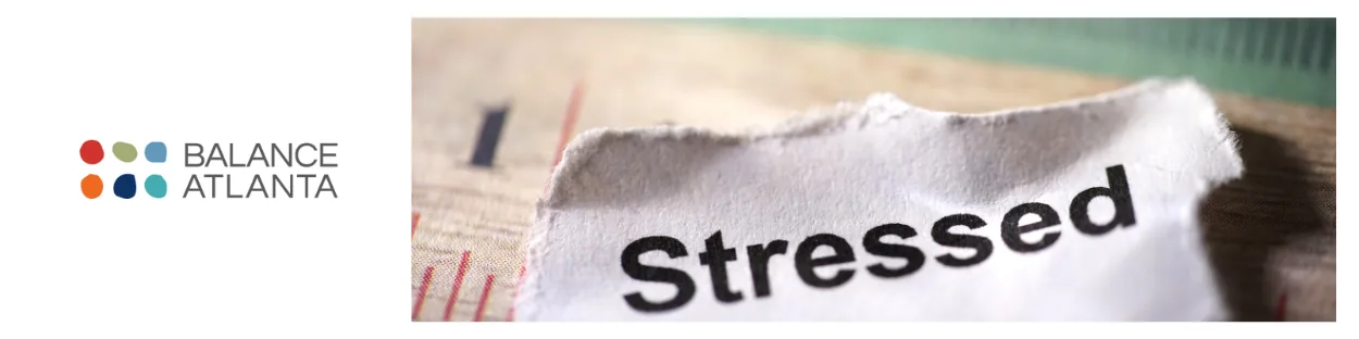 Balance Atlanta logo at left with a torn piece of paper on the right showing the word "Stressed" in bold.