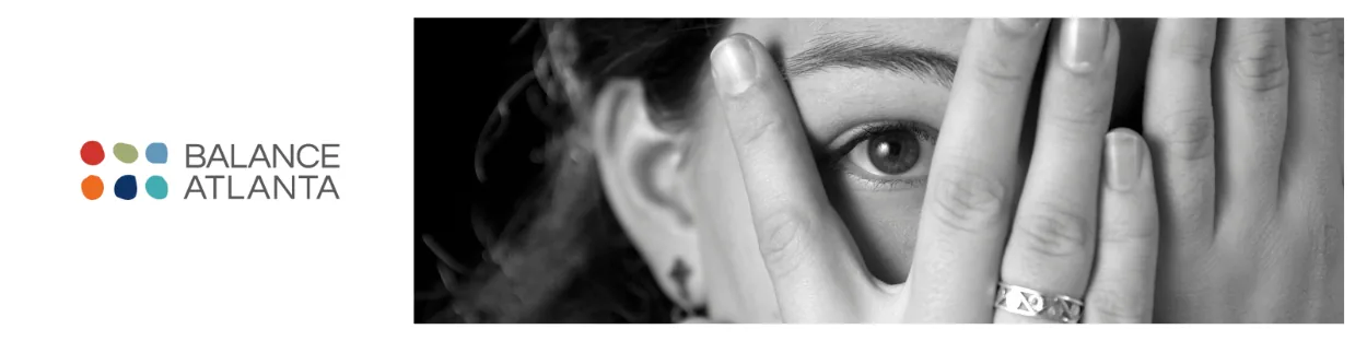 Balance Atlanta logo on the left; black-and-white photo on the right of a person covering most of their face with hands, one eye peeking through fingers.
