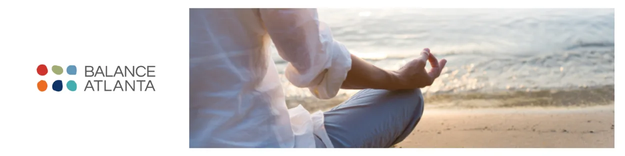 Person seated cross-legged on a beach near the water, meditating with one hand in a meditation gesture; Balance Atlanta logo on the left.