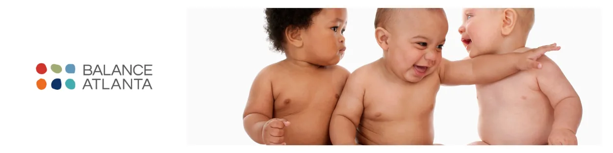Three shirtless babies sitting and interacting next to a Balance Atlanta logo on a white background.