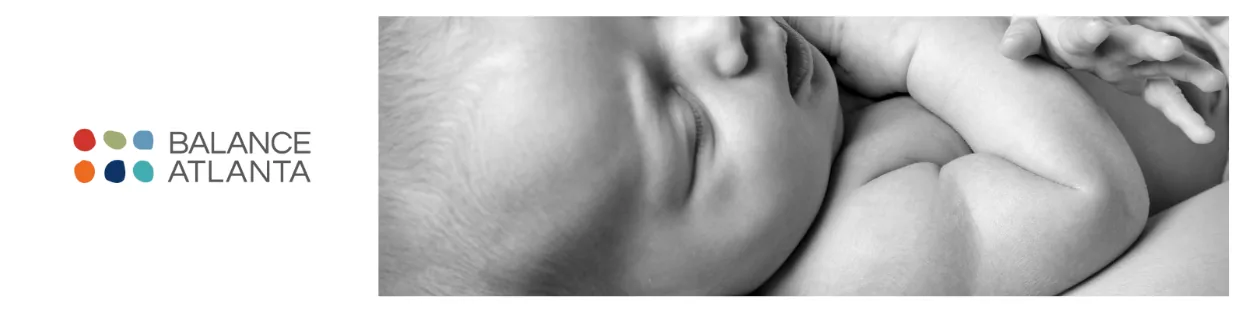 Sleeping baby with folded arms and the Balance Atlanta logo at left