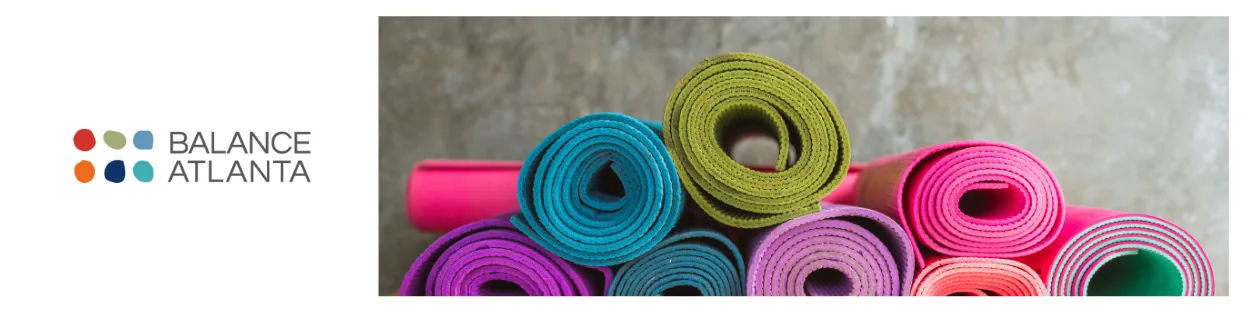 Balance Atlanta logo at left with a row of colorful rolled yoga mats stacked on the right