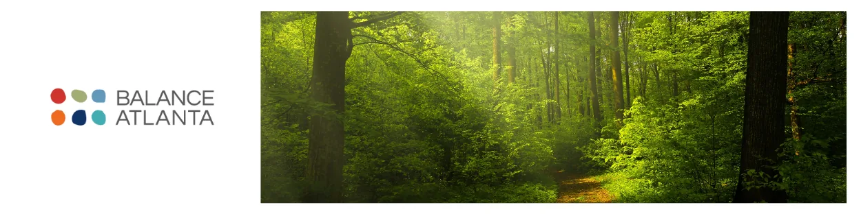 Balance Atlanta logo at left with a sunlit green forest trail and trees on the right