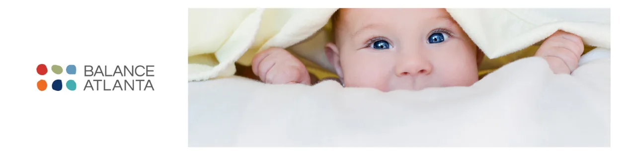 Baby peeking out from under a blanket on the right, with the Balance Atlanta logo visible at left.