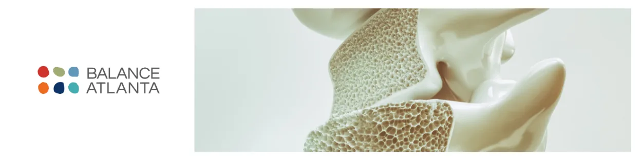 Close-up of a porous vertebra bone model showing spongy bone structure, with the Balance Atlanta logo on a white background.