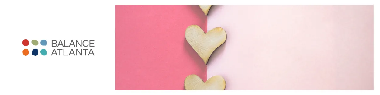 Balance Atlanta logo at left with three wooden heart shapes along the seam between a darker pink and a pale-pink background.
