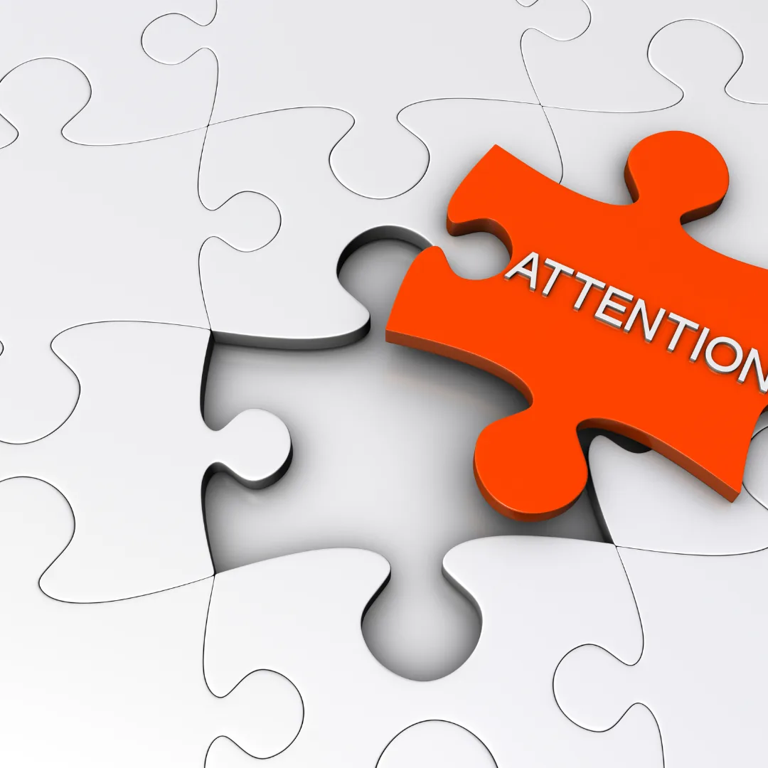 Orange puzzle piece labeled "ATTENTION" positioned to fit into an empty space among white puzzle pieces