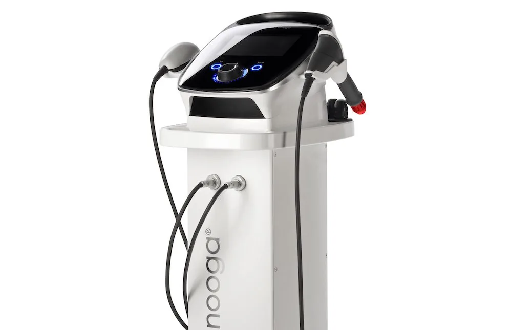 Shockwave therapy machine with two handheld applicators and a digital control panel, used in chiropractic treatment for muscle spasms and inflammation