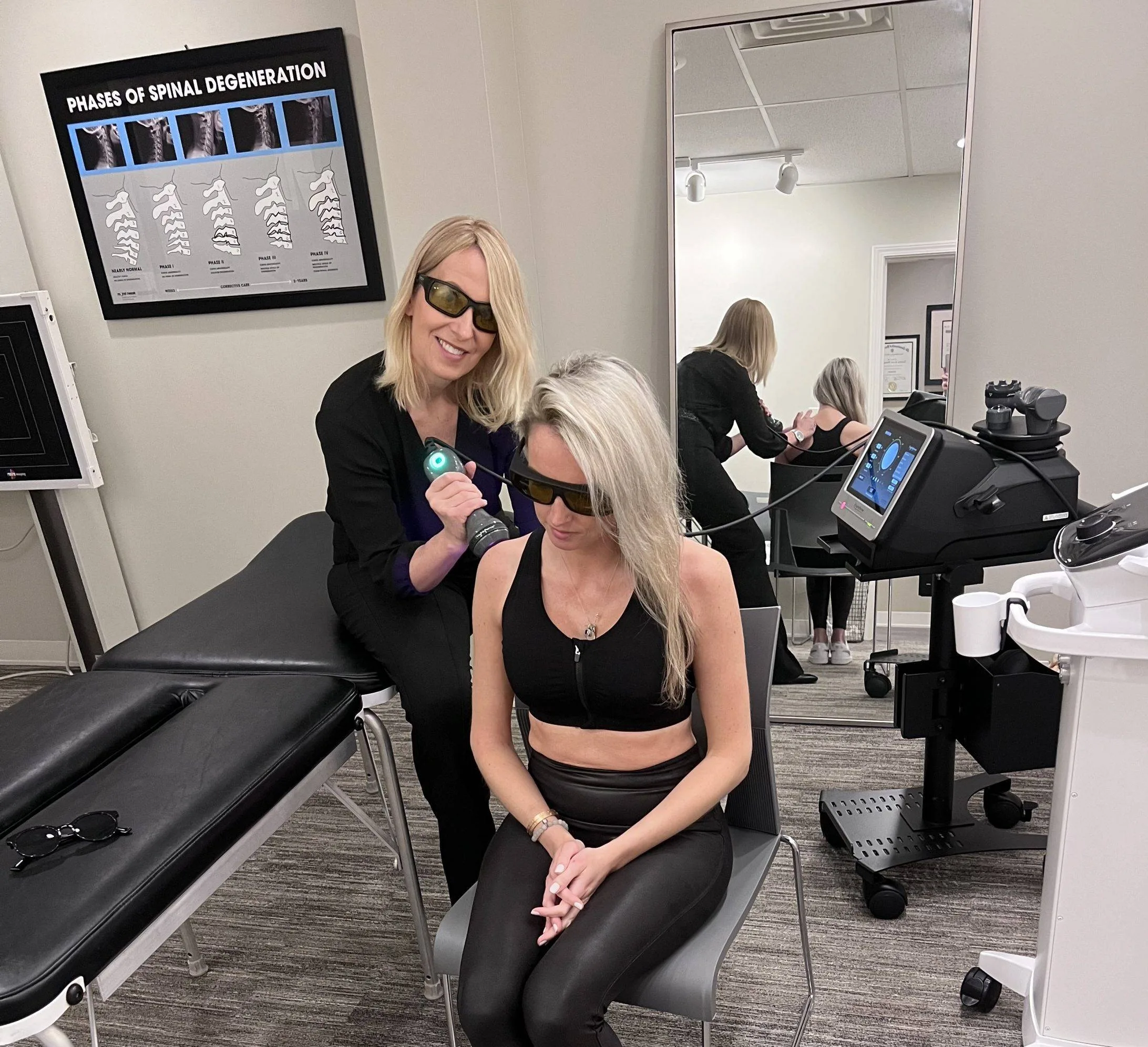 Practitioner using laser therapy on a patient at Balance Atlanta
