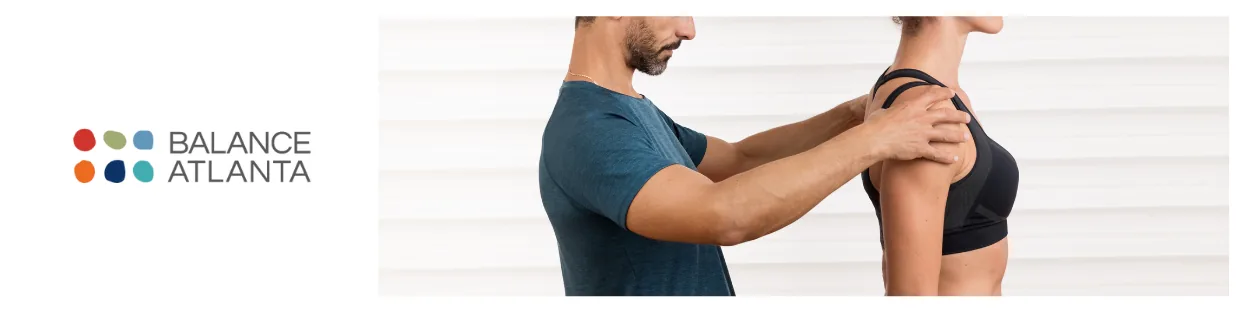 Clinician adjusting a patient's shoulder to assess posture, with the Balance Atlanta logo visible at left.