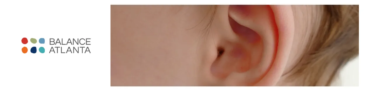 Close-up of an ear next to the Balance Atlanta logo.