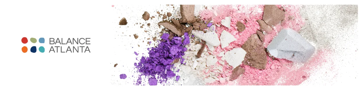 Balance Atlanta logo at left with crushed purple, pink, brown, and white makeup powders scattered on a white background.
