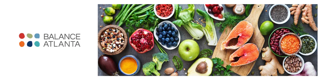 Balance Atlanta logo at left with a table spread of healthy foods: salmon, avocado, apple, blueberries, broccoli, legumes, nuts, seeds, and fresh herbs.
