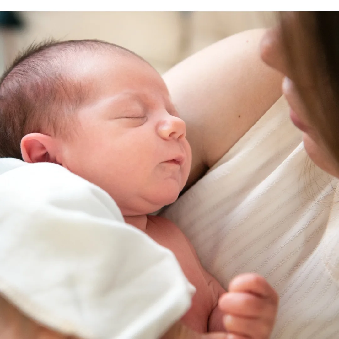 mother cradling a sleeping baby