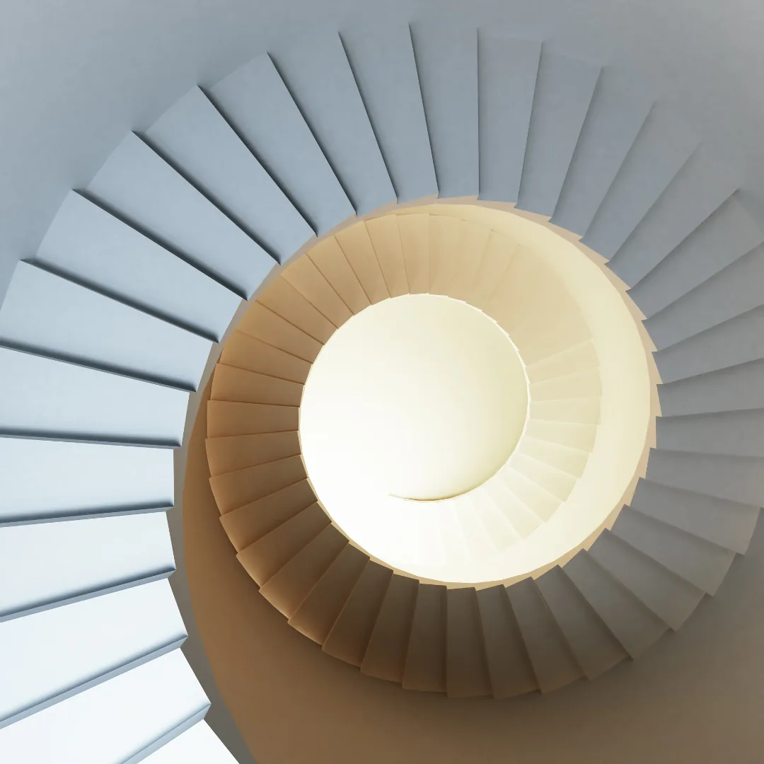 spiral staircase viewed from above, concentric steps leading to a bright central opening