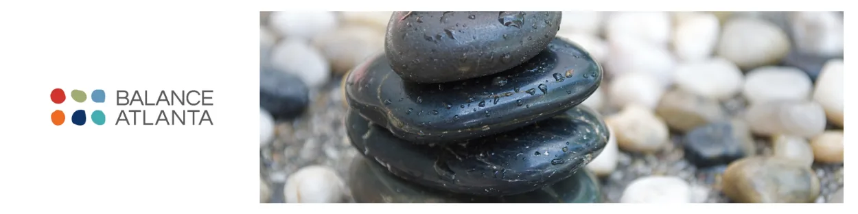 Balance Atlanta logo at left and a stack of wet black stones on pebbles at right.